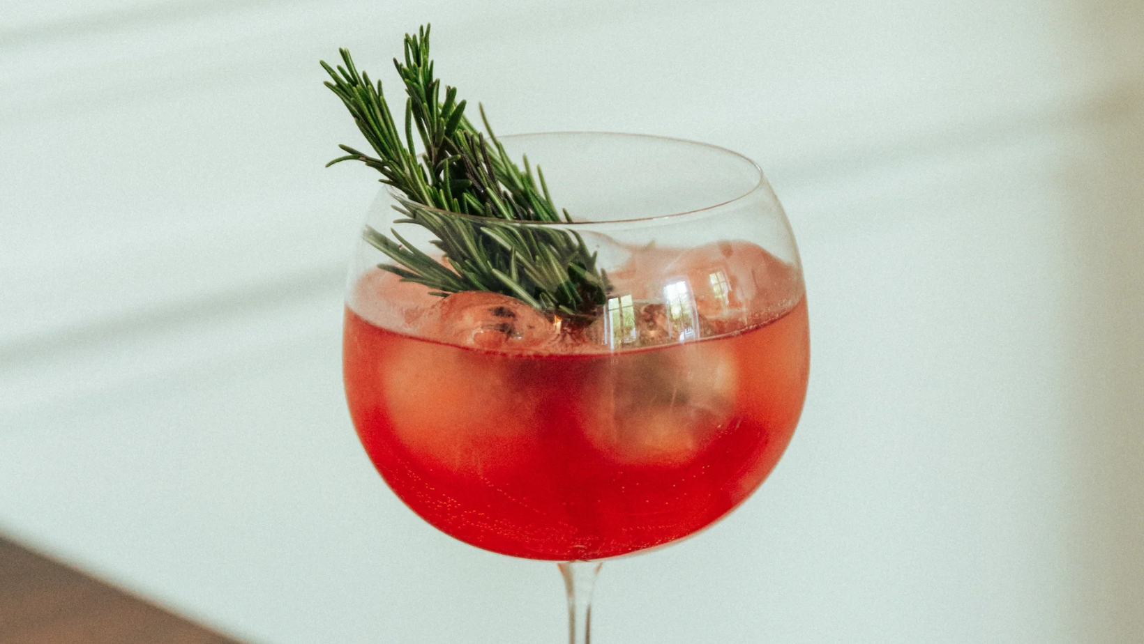 Illustration d'un Spritz sans alcool réalisé avec du BITTR JNPR, servi dans un verre élégant, accompagné d'une rondelle d'orange et de glaçons, évoquant fraîcheur et convivialité | MAISON COCKTAIL